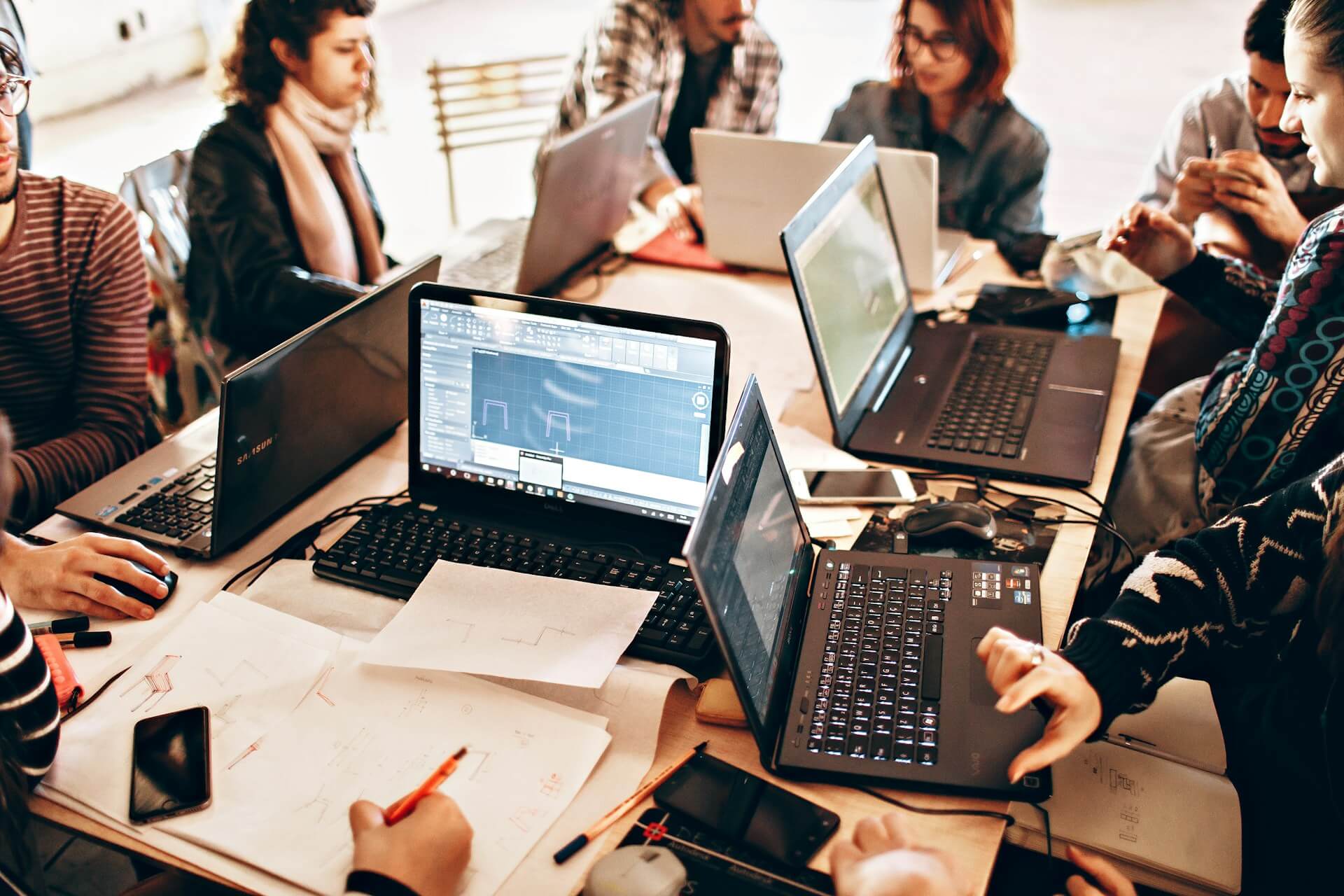 People collaborating around laptops